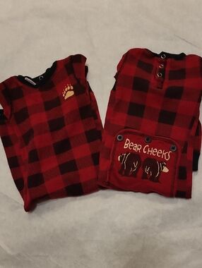 Two red buffalo plaid footless footies with bear cheeks graphic